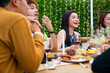 © CandyRetriever  - Group of diversity Asian millennial people friends enjoy outdoor garden dinner party eating food and drinking wine with talking together. Reunion friendship meeting celebration and night life concept.