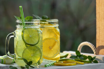 Wall Mural - Cold refreshing homemade lemonade with mint, lemon and lime in mason jars