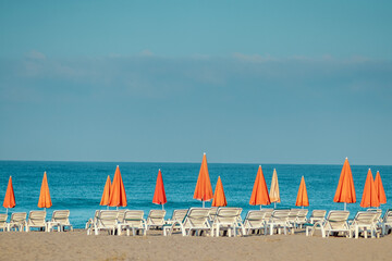 Wall Mural - Morning sea, beach, empty sun beds for vacationers. Vacation concept.