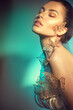 © Subbotina Anna - Beauty model girl in colorful bright neon lights posing, fashion make up with butterfly. Portrait of beautiful summer young woman in UV. Art design colorful make up with golden butterflies.