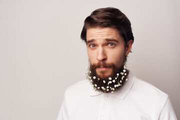 bearded man in white shirt flowers decoration in hair lifestyle