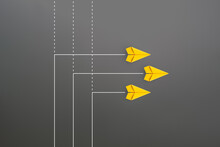 New Normal Concept With Group Of Yellow Paper Planes In New Direction On Gray Background
