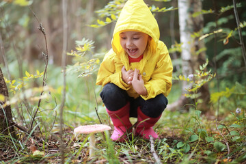 Children in the village walk through the autumn forest and gather mushrooms. Children in nature are walking in nature. Rural walk in autumn.