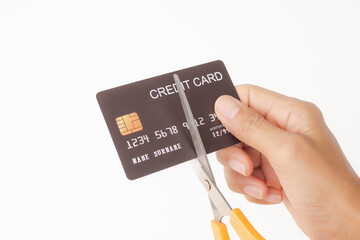 Wall Mural - Cutting credit card with scissors  on white background. Solve problems extravagant spending. stop pay. planing earn investment and saving money future for 2022 new year. finance and business concept.