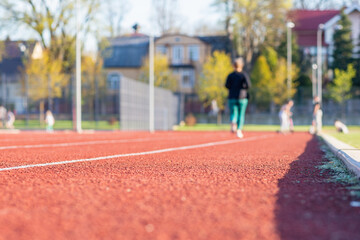 Woman running treadmill of a stadium around. Activity for weight loss and a healthy lifestyle.Selective focus.