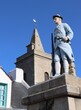 The church of Houat island and the statue of the marine rifleman in memory of the islanders who died for France during the two world wars , in Brittany, Morbihan 