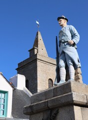 Canvas Print - The church of Houat island and the statue of the marine rifleman in memory of the islanders who died for France during the two world wars , in Brittany, Morbihan 