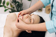 © uflypro - Female enjoying relaxing face massage in cosmetology spa centre. Body care, skin care, beauty treatment. Wellness and beauty salon. Relaxing and health. Spa woman facial massage