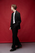 © monchak - young guy posing in a casual suit on a red background