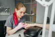 © Татьяна Максимова - Process of manicure in salon. Young manicurist.