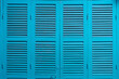 Vintage deep sky blue colour wood door, Outdoor classic louver window with horizontal wooden pattern, Texture background.