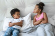 © Stock 4 You - African American sister and brother little children quarreling lying in bed