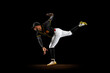 Professional baseball player, pitcher in sports uniform and equipment practicing isolated on a black studio background. Team sport concept