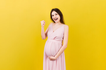 Wall Mural - Young beautiful pregnant woman on isolated colored background celebrating surprised and amazed for success with arms raised and open eyes. Winner concept