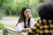 © ADDICTIVE STOCK - Lesbian couple of multiethnic women holding hands near lake