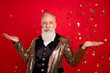 Photo of optimistic beard elder magician man with decoration wear gold jacket isolated on red color background