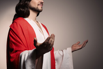 Poster - Jesus Christ reaching out his hands on beige background, closeup