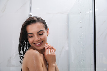 Poster - Beautiful young woman taking shower at home. Space for text