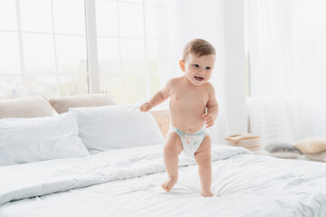 small little caucasian baby newborn infant making first steps, cute toddler kid child girl son boy d
