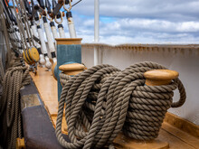 Traditional Wooden Cleat and Coiled Ropes, On Starboard Of American Coastguard Tallship Eagle Visiting Reykjavik Harbour, Iceland.