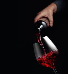 Poster - Pouring red wine in a glass goblet.