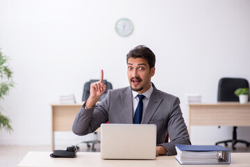 Young male employee working in the office