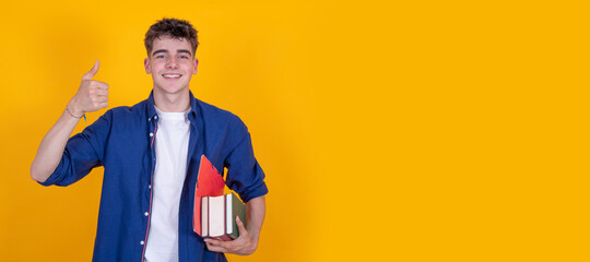 Wall Mural - teen boy with books isolated on background