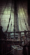 Old pirate ship with sail and mast as gloomy vintage retro background