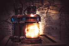 Old Vintage Light Lantern With Old Antique Map On Background As Adventure Background