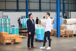 © sittinan - Happy business people talking on meeting at factory industry or Mature company manager greeting a worker  in industrial facility or warehouse