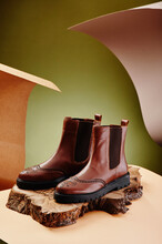 Brown Leather Chelsea Boots Made Of Genuine Leather In Classic Style On A Wooden Cut. Close-up. High Quality Photo