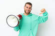 © luismolinero - Young handsome caucasian man isolated on white background holding a megaphone and proud and self-satisfied