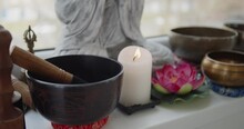 Tibetan Singing Bowls, Candle, Lotus Flower And Buddha Statue Standing Together On A Windowsill In Yoga Studio. Meditation And Relaxation Concept.
