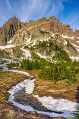 Wall Mural - volcanic mountain landscape in the summer with snow melting and forming small streams of runoff.