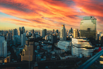 Skyscrapers and beautiful cloud in sunset time at rooftop building in the metropolis, horizontal view.