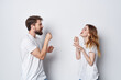 © SHOTPRIME STUDIO - cheerful young couple in white t-shirts communication friendship emotions