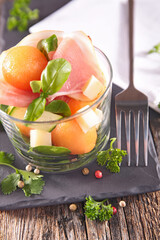 Wall Mural - melon salad with prosciutto ham,  cheese and basil