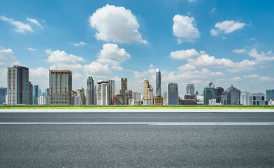 Wall Mural - Side view of asphalt road with modern city skyline