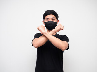 Asian man black shirt with mask cross arm disagree say no looking at camera on white isolate background