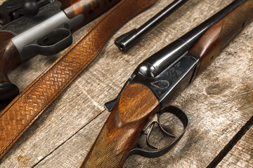 Wall Mural - Many hunting rifles on weathered wooden surface