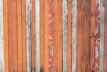 Orange Flaky Paint On A Wooden Fence.