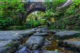 Fototapeta Uliczki - Strem under a small stone bridge arch. Sintra Portugal