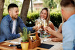 © djile - Group of Happy friends in the restaurant and toasting with glasses of wines
