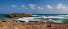 Panorama Of The Deserted Rocky Ocean Coast On A Sunny Day.Azure-orange Panorama Of The South Australian Rocky Coast. Ocean Waves Roll On The Rocky Shore. Protruding From The Water Of The Rock. 