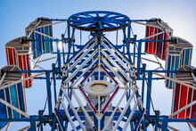 The Zipper Ride At A Carnival Against A Blue Sky.