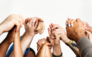 Closeup of diverse people holding hands