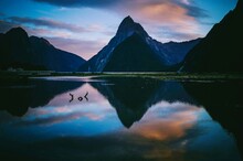 Reflection Of Mountain In Lake Against Sky During Sunset