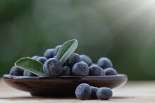 Fresh Organic Blueberries In Wood Plate On Wooden Table.