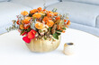 Floral arrangement of roses inside decorated pumpkin