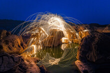 Burning Steel Wool Being Spun Before Dusk On A Grand Canyon Rock Field Of Thailand